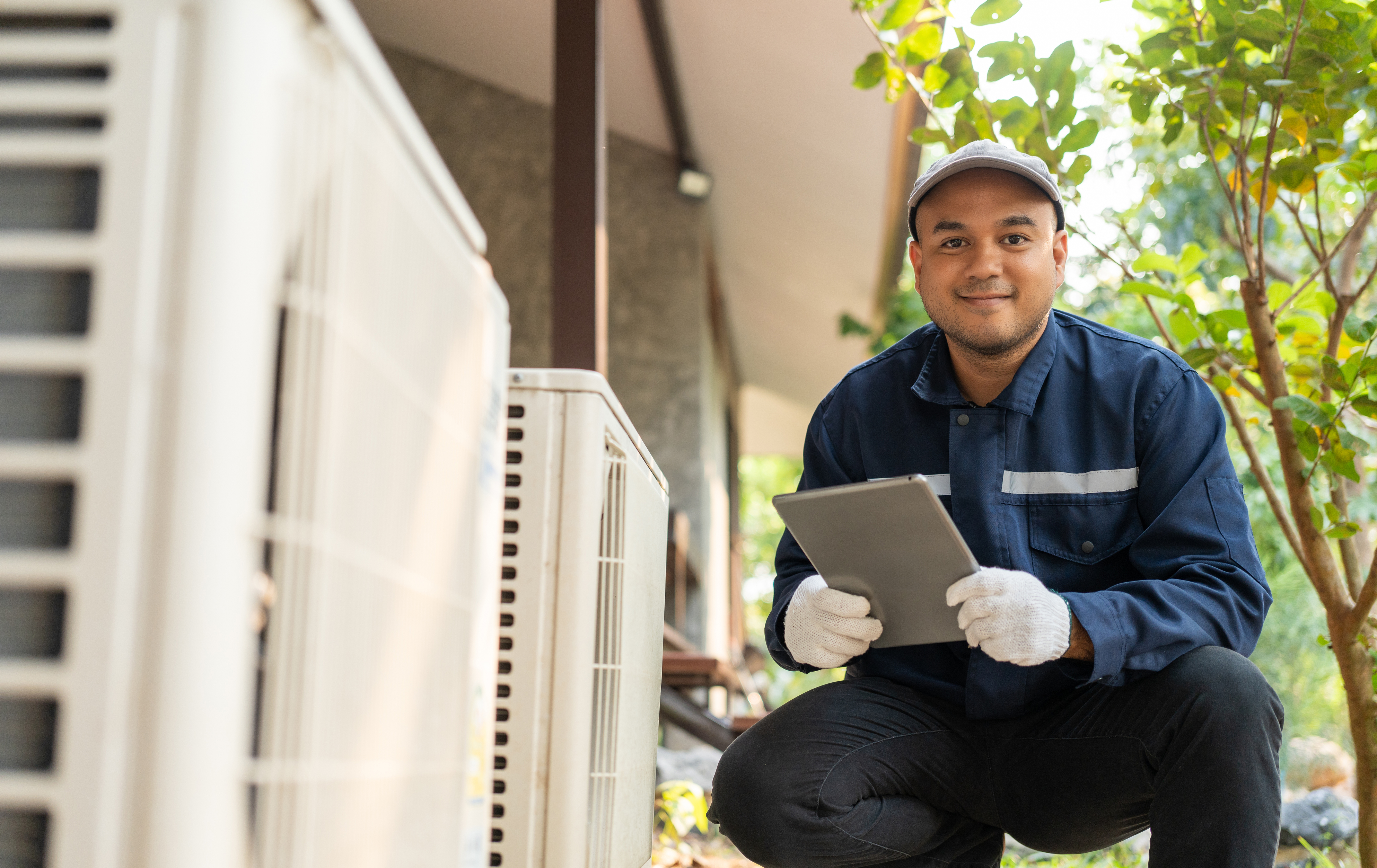 HVAC technician reviewing membership plan on tablet